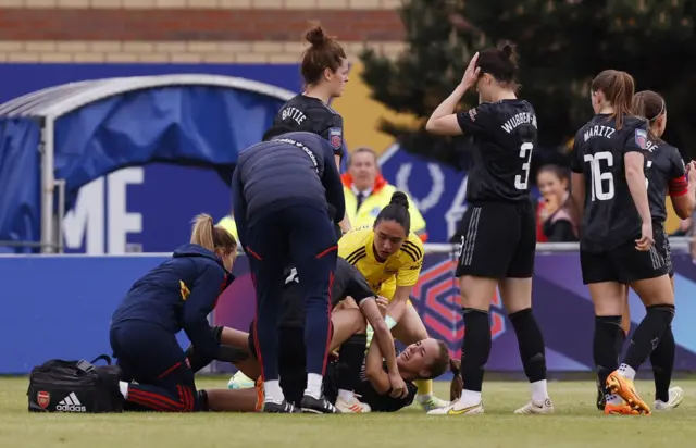 Arsenal's Lia Walti receives medical attention after sustaining an injury