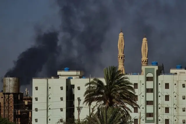 Smoke billows above buildings in southern Khartoum amid ongoing fighting between the forces of two rival generals, on May 16, 2023.