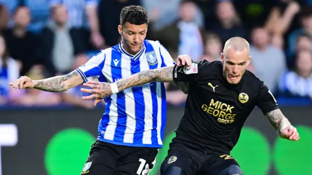 Marvin Johnson and Joe Ward challenge for the ball