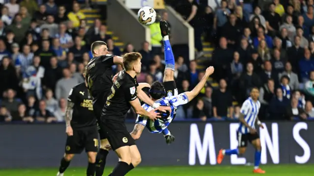 Lee Gregory tries to score with an overhead kick