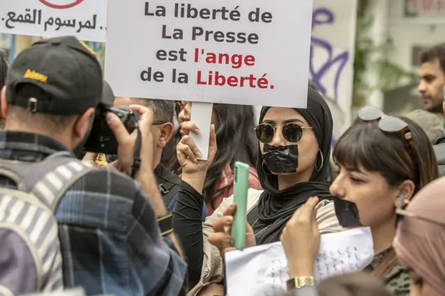 People gather by the call of Tunisian Journalists' Union to protest after the journalist Khalifa Guesmi sentenced to five years in prison under anti-terrorism legislation on May 18, 2023