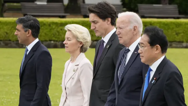 British Prime Minister Rishi Sunak, European Commission President Ursula von der Leyen, Canadian Prime Minister Justin Trudeau, US President Joe Biden, and Japan's Prime Minister Fumio Kishida walk to a flower wreath laying ceremony