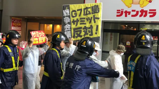 Anti-war protesters and police in Hiroshima, Japan during 2023 G7 Summit