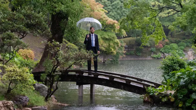 UK Prime Minister Rishi Sunak with an umbrella at the Shukkeien Garden in Hiroshima