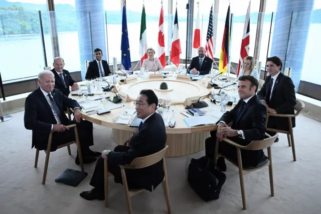 G7 leaders pose for a roundtable photo op in Hiroshima.