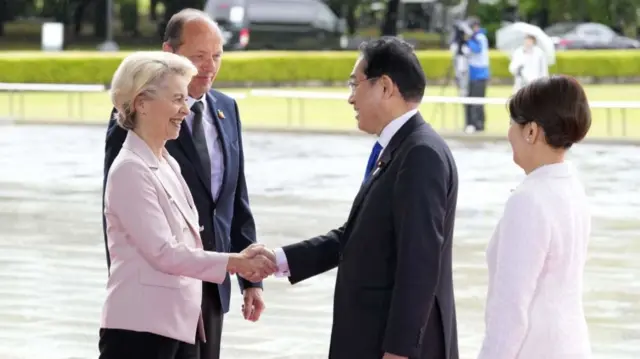 European Commission President Ursula von der Leyen and her husband Heiko von der Leyen are welcomed by Japan's Prime Minister Fumio Kishida and his wife Yuko Kishida at the Peace Memorial Park as part of the G7 Summit in Hiroshima on May 19, 2023.