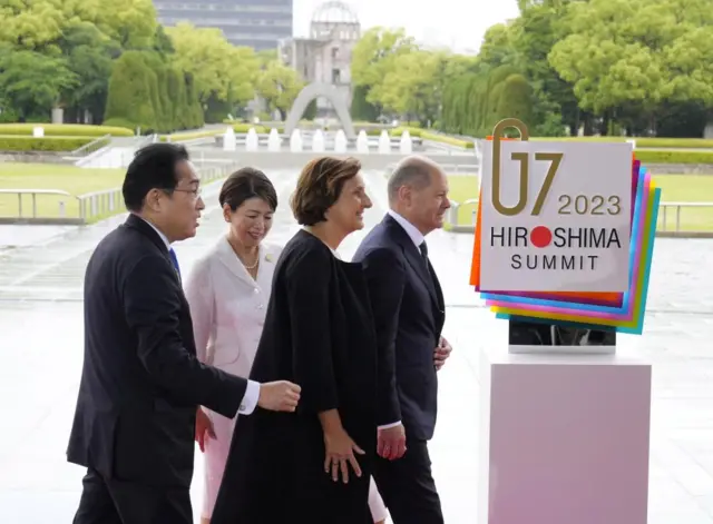 German Chancellor Olaf Scholz and Japan's prime minister Fumio Kishida, walk past Hiroshima's A-Bomb Dome memorial - one of the few buildings to survive the nuclear bombing of 1945