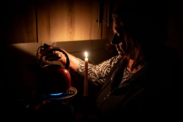 Marina Van Biljon uses a kettle in her home during loadshedding in Frankfort on May 10, 2023.