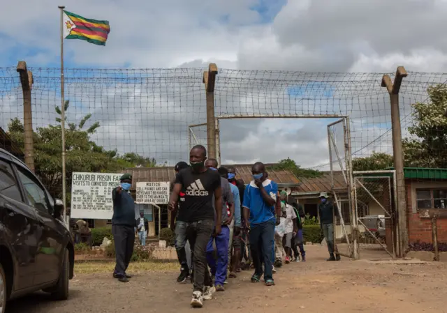 Prisoners walk out of the gates after being released at Chikurubi Maximum Prison on April 17, 2021 in Harare, Zimbabwe.