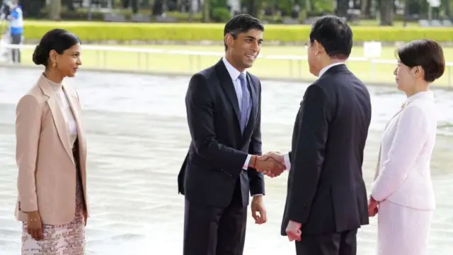 UK Prime Minister Rishi Sunak and his wife Akshata Murty are welcomed by Japan Prime Minister Fumio Kishida and First Lady Yuko Kishida at the Peace Memorial Park as part of the G7 Leaders' Summit in Hiroshima on May 19, 2023.