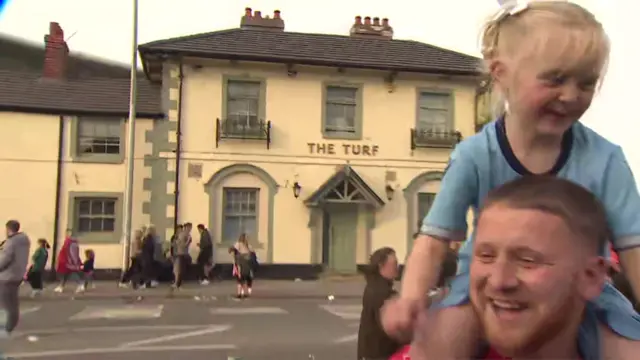 Father with daughter on shoulders