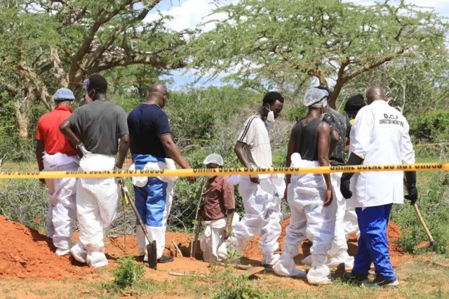 Officials inspect a forested where 90 bodies were found near the Good News International Church in Malindi town of Kilifi, Kenya on April 23, 2023.