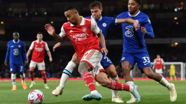 Chelsea and Arsenal players battle for the ball