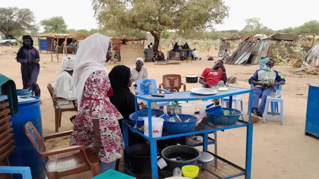 A Sudanese refugee who fled the violence in her country, sells tea and porridge to other refugees near the border between Sudan and Chad, in Koufroun, Chad