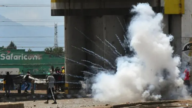 Riot police officers lob teargas canisters to disperse supporters of Kenya's opposition leader Raila Odinga of the Azimio La Umoja (Declaration of Unity) One Kenya Alliance, during protests over cost of living and Kenyan President William Ruto's government in Kisumu, Kenya 2 May 2023