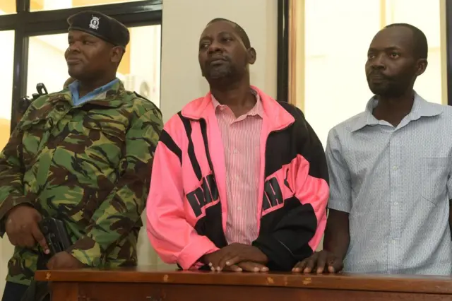 Self-proclaimed pastor Paul Nthenge Mackenzie (C), who set up the Good News International Church in 2003 and is accused of inciting cult followers to starve to death "to meet Jesus", appears in the dock with other co-accused at the court in Malindi on May 2, 2023.