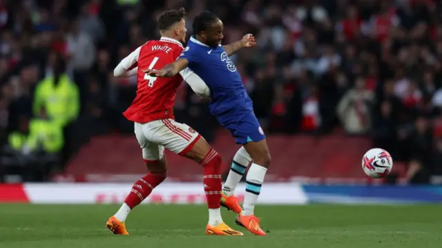 Ben white and Raheem Sterling battle for the ball
