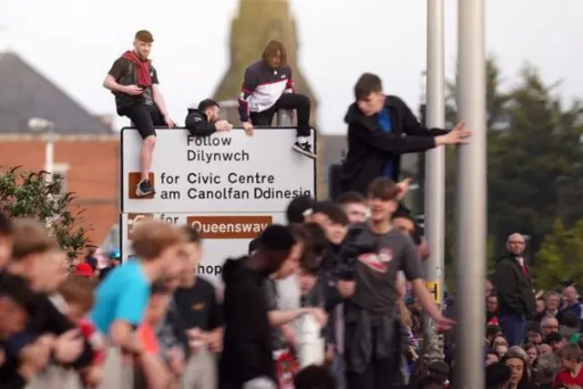 Fans on a street sign