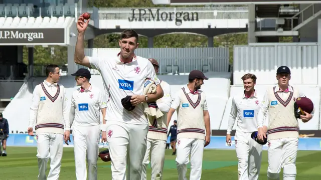 Craig Overton leads the Somerset players off the field after taking five wickets