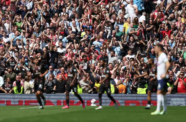 Brentford fans celebrate the third goal