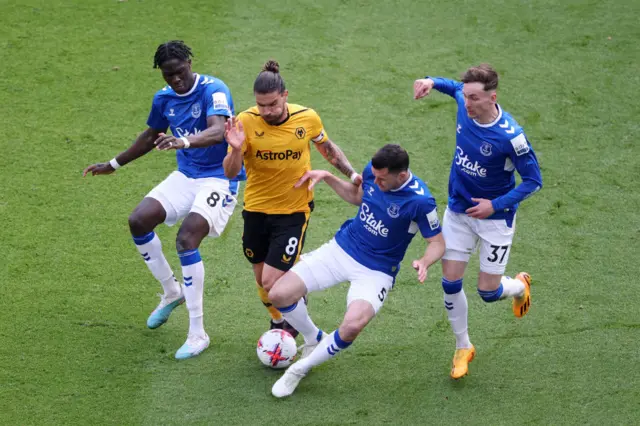 Ruben Neves is challenged by Amadou Onana, Michael Keane and James Garner