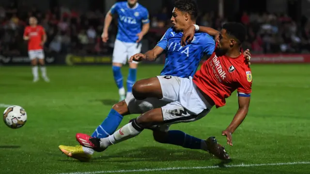 Kyle Knoyle of Stockport County and Ibou Touray of Salford City