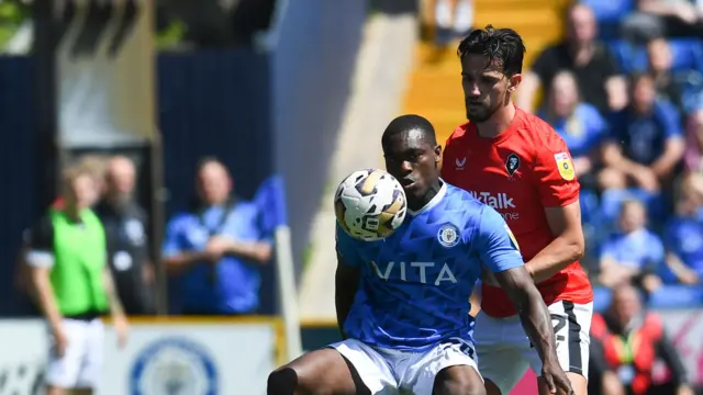 Stockport's Isaac Olaofe controls the ball