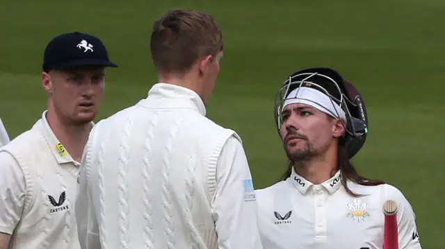 Surrey captain talking to Kent's Zak Crawley