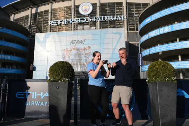 Manchester City fans celebrate winning the title