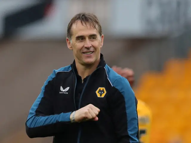 Lopetegui pats the Wolves crest on his chest.