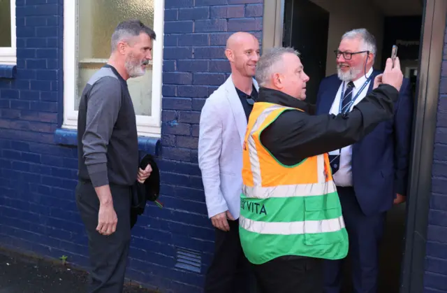 Ex-Manchester United player Roy Kean has a selfie taken with a steward outside Edgeley Park