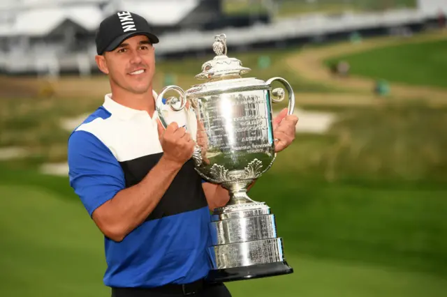 Brooks Koepka holds the Wanamaker trophy