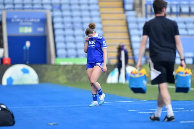 Ruby Mace covers her face after being sent off the field.