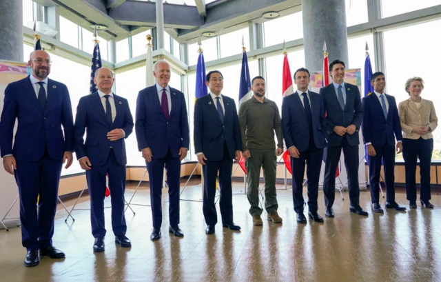 President Joe Biden and Ukrainian President Volodymyr Zelenskiy, and other G7 leaders pose for a photo before a working session on Ukraine