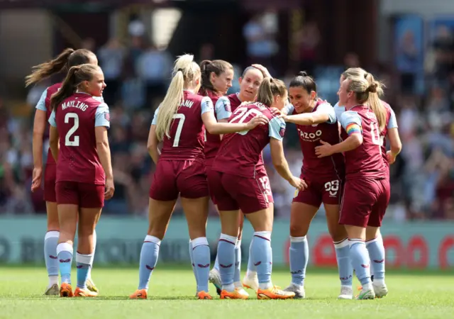 Villa players gather to celebrate their equaliser against Liverpool.