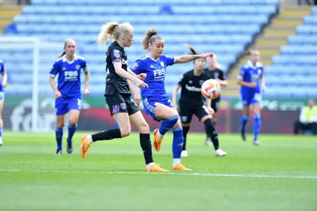 Hannah Cain of Leicester challenges Grace Fisk for the ball.