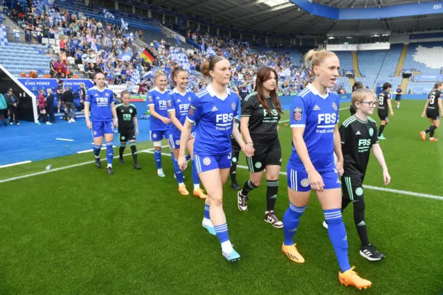 Leicester and West Ham players take to the field.