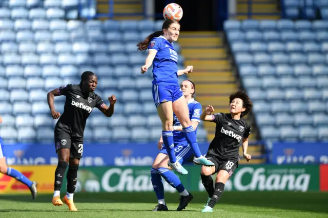 Shannon O'Brien wins an aerial duel in midfield.