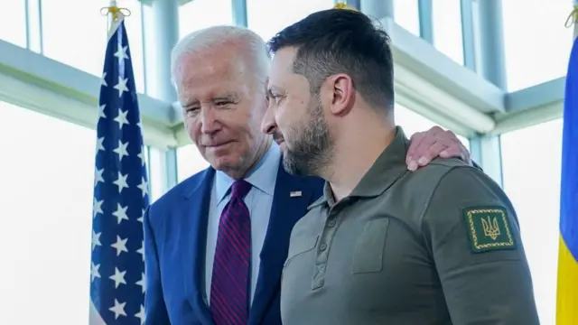 President Joe Biden, walks with Ukrainian President Volodymyr Zelensky ahead of a working session on Ukraine during the G7 Summi