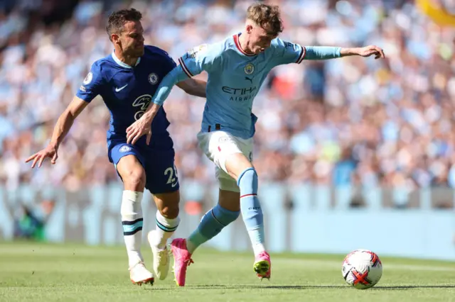 Cole Palmer is challenged by Cesar Azpilicueta