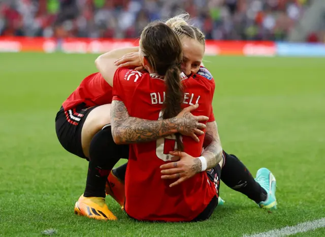 Manchester United's Leah Galton and Hannah Blundell celebrate after Lucia Garcia scores their second goal v Man City