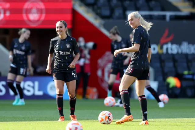 Katie Zelem and Millie Turner warm up ahead of the Manchester derby.