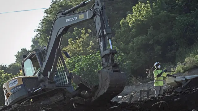 A digger and an employee working to dismantle a shantytown in Mayotte, France - 23 May 2023