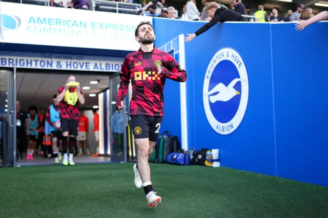 Bernardo Silva emerges for the warm up at Brighton