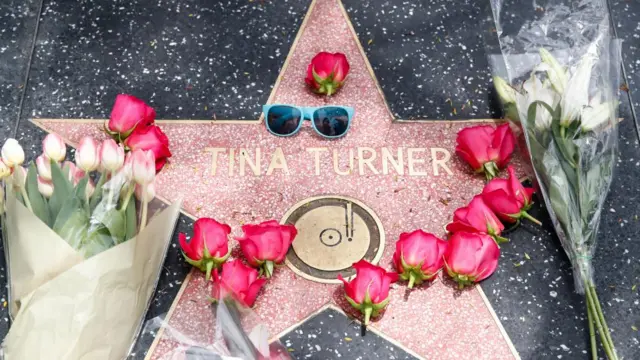 Flowers and a pair of sunglasses placed on Tina Turner's star on the Hollywood Walk of Fame