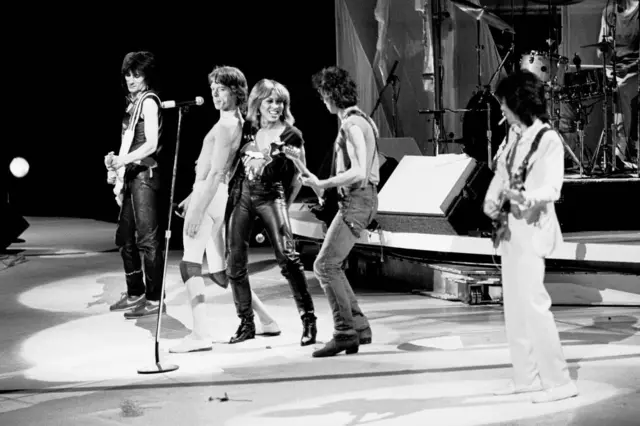 Ronnie Wood (far left) performs as part of the Rolling Stones alongside Tina Turner (centre)