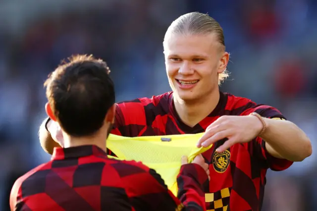 Erling Haaland smiles during the warm up to the Brighton match