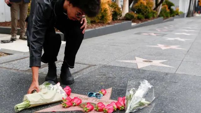 A man lays flowers on Turner's star on the Hollywood Walk of Fame in Los Angeles