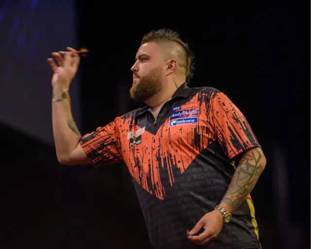 Michael Smith throwing a dart