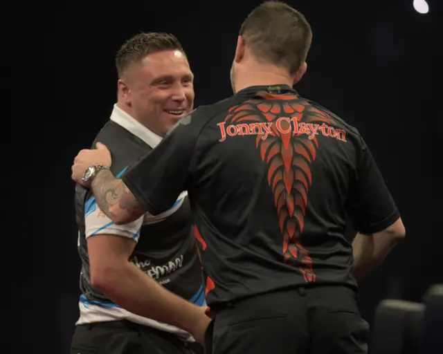 Gerwyn Price and Jonny Clayton embrace each other at the oche